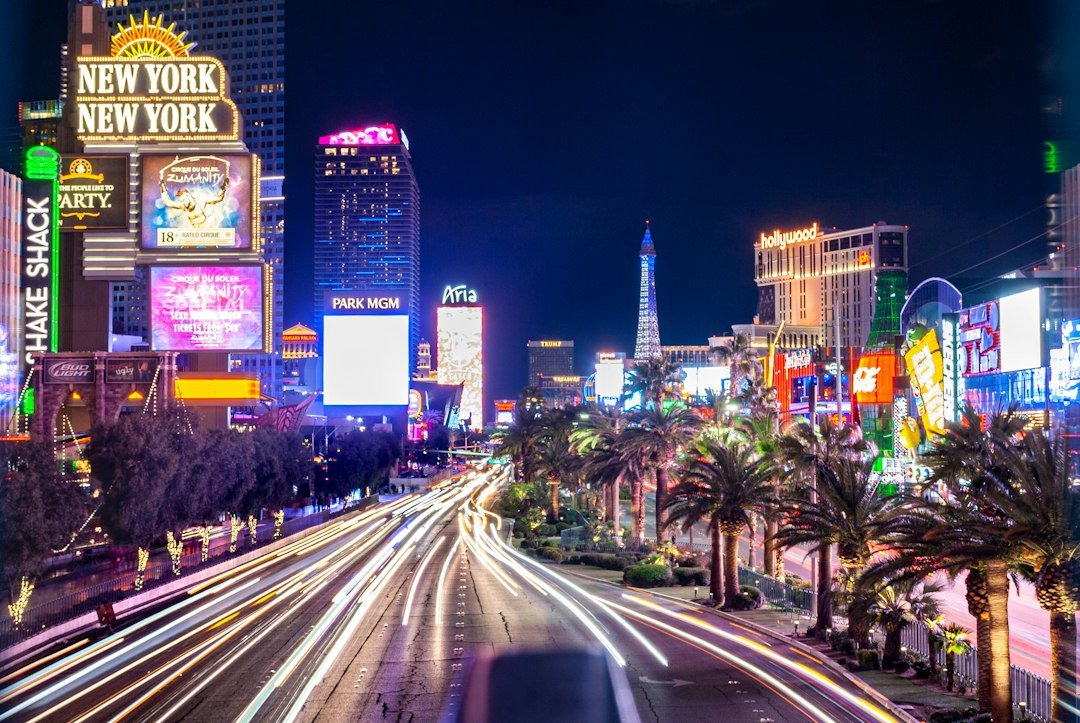 Las Vegas Boulevard glowing with neon signs and moving traffic at night