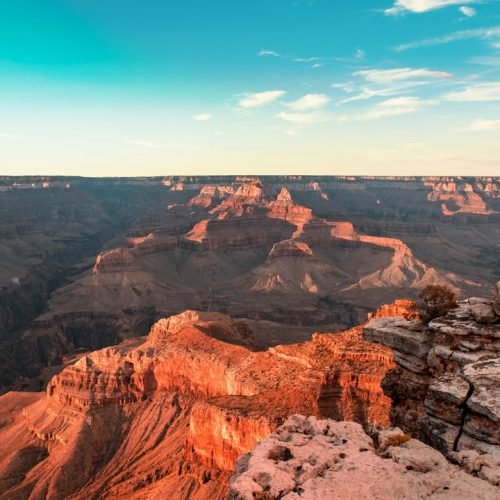 Grand Canyon rock formations extending beneath a clear blue Arizona sky
